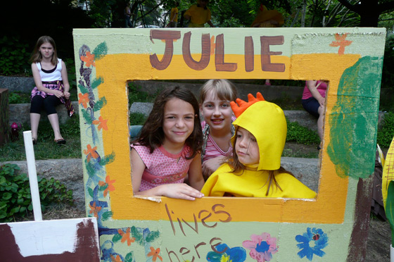 Julie, a girl who likes to garden, with her chicken and mother.